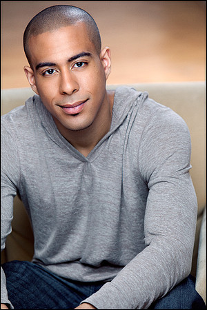 Wry smile, crisp lighting, 3/4 angle — a headshot with attitude."