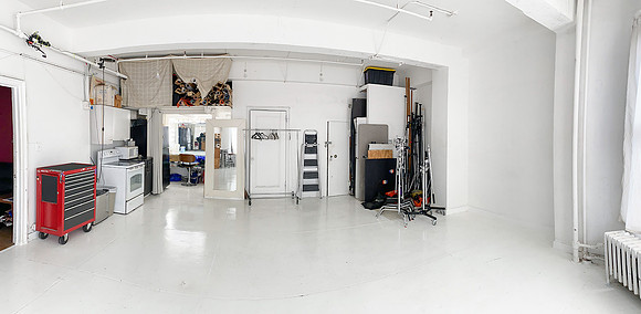 Wide view of a Chelsea photo studio with white floors, natural light, and open space for portraits and small shoots