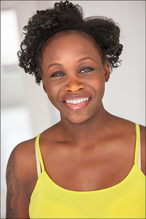Professional NYC actor headshot of smiling Black woman in yellow top, confident and approachable for commercial castings.